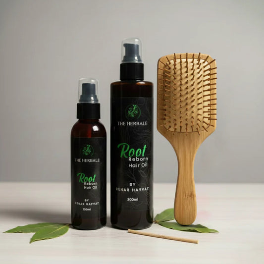 Root Reborn Hair Oil by Sehar Hayvat - 150ml and 300ml bottles displayed with a bamboo hairbrush and fresh leaves, highlighting the natural ingredients for healthy and stronger hair.