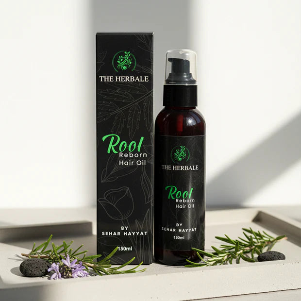 Root Reborn Hair Oil by Sehar Hayvat - 150ml bottle with packaging displayed alongside fresh rosemary and natural ingredients for healthier, stronger hair.