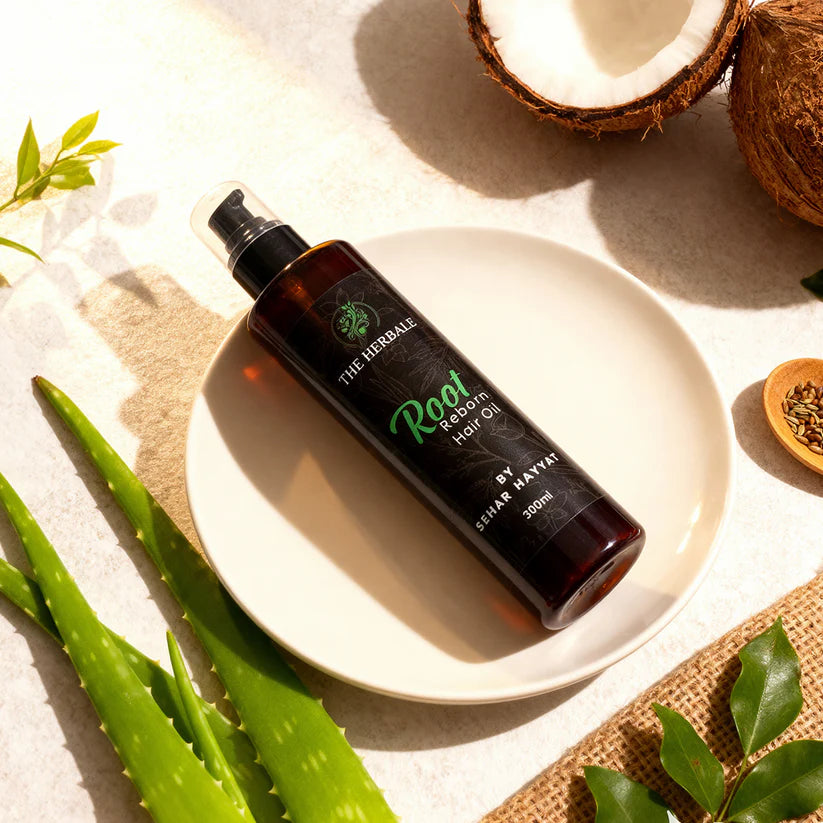 Root Reborn Hair Oil by Sehar Hayvat - 300ml bottle surrounded by fresh coconut, aloe vera, and natural ingredients, showcasing a revitalizing hair care solution for nourishment and strength.