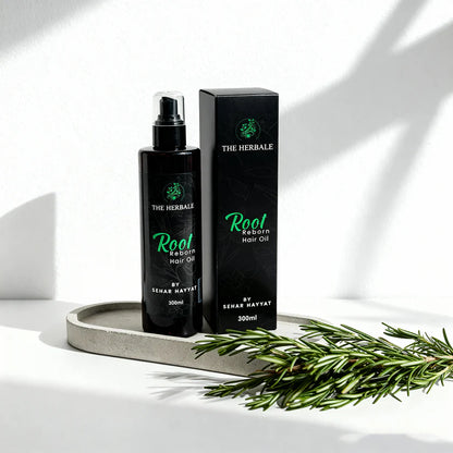 Root Reborn Hair Oil by Sehar Hayvat - 300ml bottle with packaging displayed alongside fresh rosemary, offering a natural solution for hair growth and nourishment in a clean, minimalistic setting.